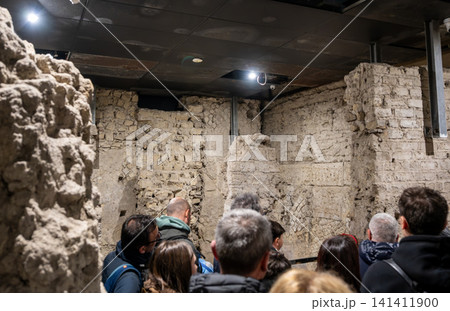 Naples, italy. December 29, 2024. Visitors engrossed in the historical underground archaeological site, witnessing centuries old roman architecture and heritage in naples Naples, italy. December 29, 2024. Visitors engrossed in the historical underground archaeological site, witnessing centuries old roman architecture and heritage in naples 141411900