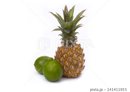 Pineapple and lime on a white background. Lime and pineapple close-up on an isolated white background. 141411953