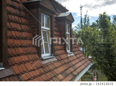 Windows from the rooms of the house on the roof of the building 141413019