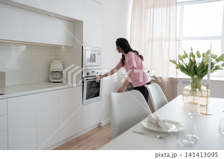 Portrait of a woman in the kitchen of her home for health diet or nutrition. Smile, food and cooking 141413095