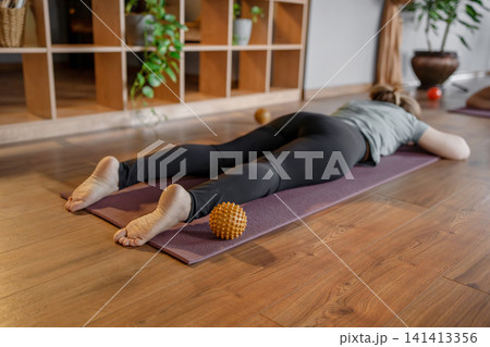Peaceful yoga position for relaxation, gentle and relaxing yoga pose to ease tension and stress. Baby pose for lower back relaxation 141413356