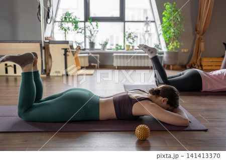 Women three generations doing different yoga exercises lying on back. Women's health of joints and spine Women three generations doing different yoga exercises lying on back. Women's health of joints and spine 141413370