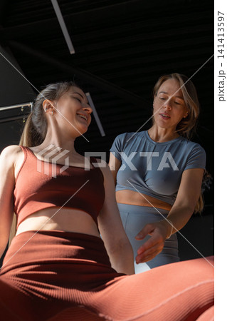 Foot work and core exercise on a Pilates Reformer machine illuminated by sunlight. Fit, healthy and strong authentical body. Fitness concept. 141413597