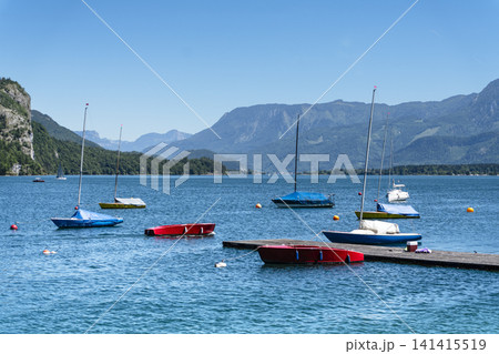 Sailboats on Lake Wolfgangsee in the Salzkammergut, illustrating scenic lake tourism in Austria and classic alpine summer vibe. Sailboats on Lake Wolfgangsee in the Salzkammergut, illustrating scenic lake tourism in Austria and classic alpine summer vibe. 141415519