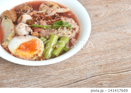 boiled fish and shrimp meatball with morning glory topping mashed pork couple creamy egg in spicy red sauce tom yum soup on bowl boiled fish and shrimp meatball with morning glory topping mashed pork couple creamy egg in spicy red sauce tom yum soup on bowl 141417689