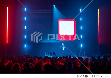 Speaker engaging audience with bright stage lighting Speaker engaging audience with bright stage lighting 141417888