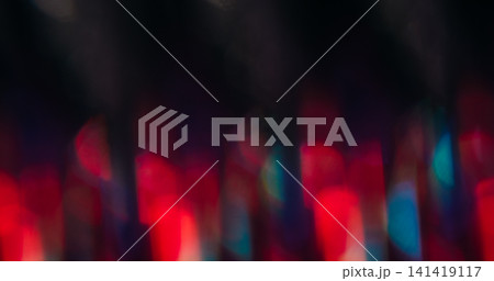 Bokeh flash. Blur color flare. Defocused fluorescent blue red lens shine flicker beam gleam on abstract art dark black background. 141419117