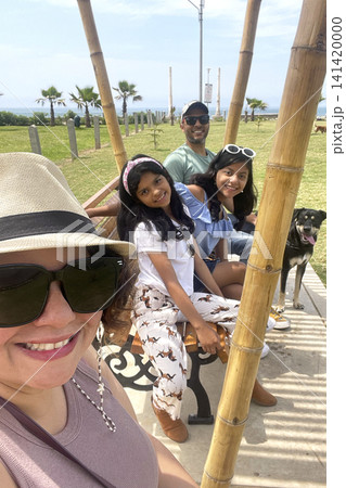 Family and dog on park bench at coastal boardwalk. UGC Family and dog on park bench at coastal boardwalk. UGC 141420000