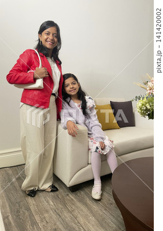 Sisters posing together in modern living room Sisters posing together in modern living room 141420002