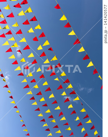 Red and yellow flags on blue sky backround 141420577
