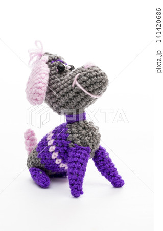 Knitted woolen dog on a white background Knitted woolen dog on a white background 141420686