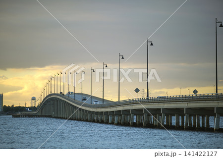 Barron Collier Bridge and Gilchrist Bridge in Florida with moving traffic. Transportation infrastructure in Charlotte County connecting Punta Gorda and Port Charlotte over Peace River 141422127