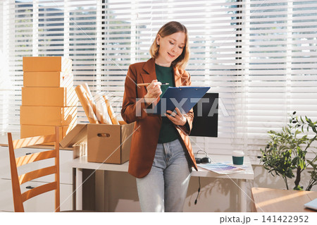 Logistics, small business woman with checklist for stock, clothes order or retail inventory management. Shipping, writing or person at ecommerce startup store for sme delivery with fashion designer Logistics, small business woman with checklist for stock, clothes order or retail inventory management. Shipping, writing or person at ecommerce startup store for sme delivery with fashion designer 141422952