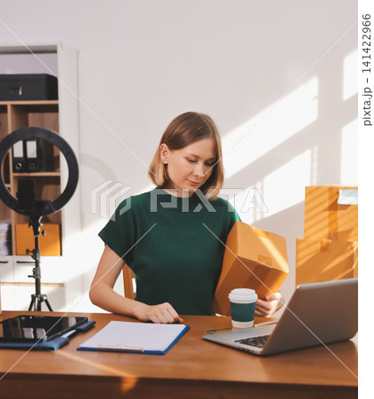 Logistics, small business woman with checklist for stock, clothes order or retail inventory management. Shipping, writing or person at ecommerce startup store for sme delivery with fashion designer 141422966