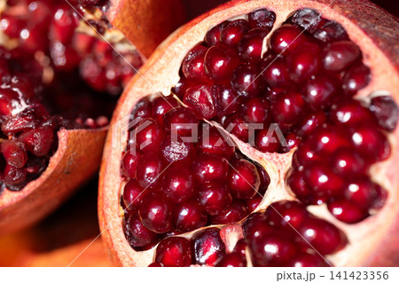 Pomegranate fruit halved, showing nutrient-rich arils a healthy source of antioxidants 141423356