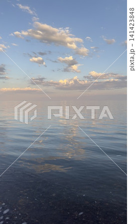 Soft evening sky over tranquil sea with pastel cloud reflections Soft evening sky over tranquil sea with pastel cloud reflections 141423848