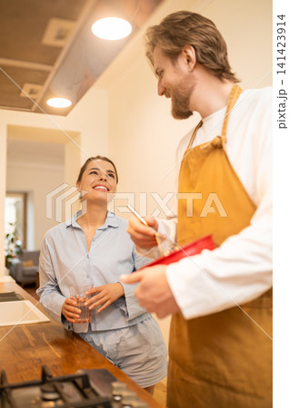 Couple in the kitchen making coffee for breakfast and feeling joyful Couple in the kitchen making coffee for breakfast and feeling joyful 141423914