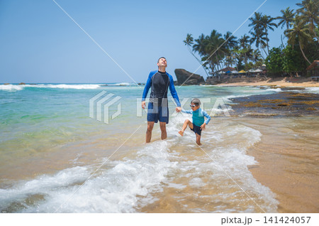 Caucasian father and son playing on tropical beach in Sri Lanka, joyful moment Caucasian father and son playing on tropical beach in Sri Lanka, joyful moment 141424057
