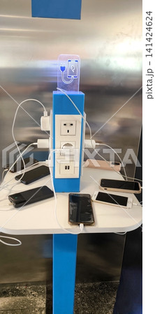 Mobile phone charging station in a public place Mobile phone charging station in a public place 141424624