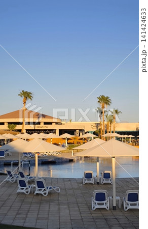 Tropical oasis: resort pool under the scorching sun Tropical oasis: resort pool under the scorching sun 141424633