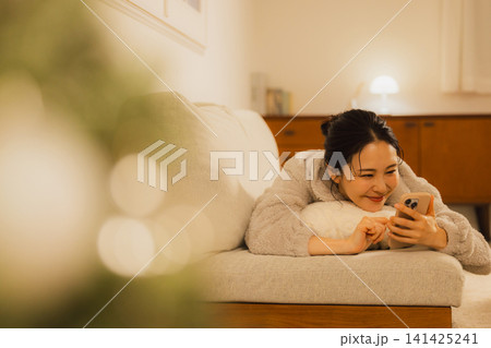 夜スマホを見る女性   141425241