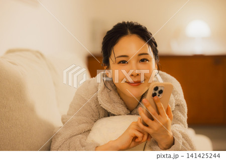 夜スマホを見る女性   141425244