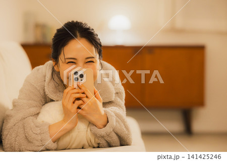 夜スマホを見る女性   141425246