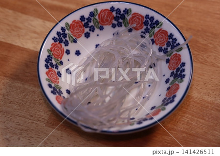 Noodles in Floral Bowl on Wooden Surface Noodles in Floral Bowl on Wooden Surface 141426511