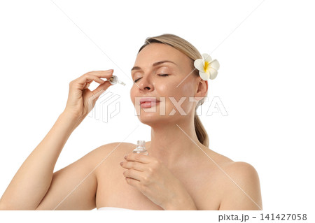 Woman applies skincare serum gently, isolated on white, PNG Woman applies skincare serum gently, isolated on white, PNG 141427058