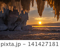 Scenery view of sunset over lake Baikal, Russia looking through an Ice spike and Icicle. The water in Lake Baikal freezes in bizarre shapes in winter season. 141427181