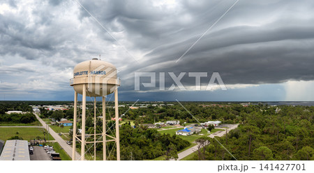 Dark storm clouds gather over Charlotte Harbor water tower in Florida during summer thunderstorm with heavy rainfall. Dark storm clouds gather over Charlotte Harbor water tower in Florida during summer thunderstorm with heavy rainfall. 141427701