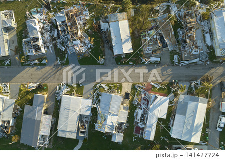 Consequences of natural disaster in southern Florida after hurricane season. Severely damaged houses in mobile home residential area Consequences of natural disaster in southern Florida after hurricane season. Severely damaged houses in mobile home residential area 141427724