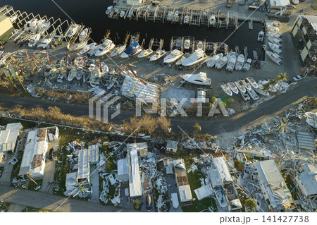 Collapsed and damaged mobile homes after hurricane Ian swept through Florida residential area. Consequences of severe natural disaster 141427738