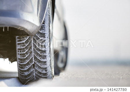 Close-up of car wheels rubber tire in deep snow. Transportation and safety concept. 141427780