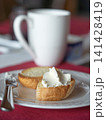 Cream cheese onbaguette on white plate. 141428419