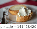 Cream cheese onbaguette on white plate. 141428420