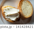 Cream cheese onbaguette on white plate. 141428421