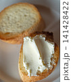 Cream cheese onbaguette on white plate. 141428422
