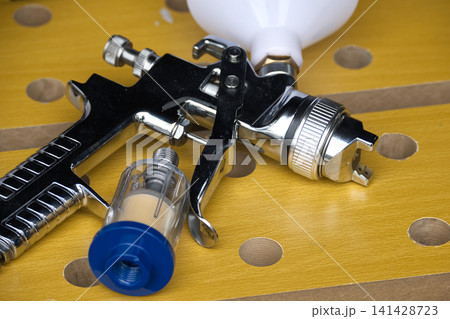Professional chrome spray gun with air filter attachment for detailed painting projects 141428723