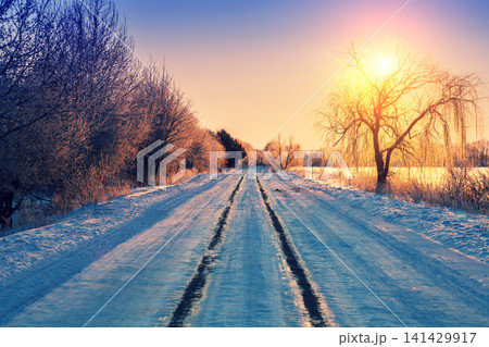 Early morning, road covered with snow at sunrise Early morning, road covered with snow at sunrise 141429917