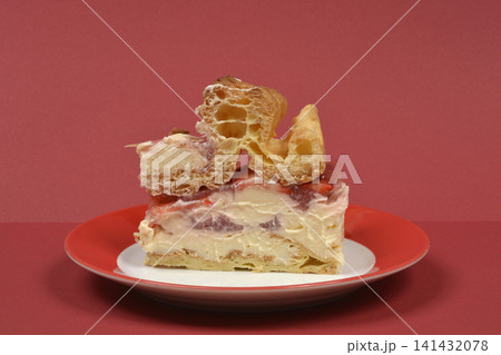 A slice of homemade karpatka cake with strawberries on a plate A slice of homemade karpatka cake with strawberries on a plate 141432078
