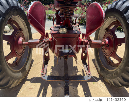 Vintage red tractor, vehicle Machine that reflects agricultural history Vintage red tractor, vehicle Machine that reflects agricultural history 141432360