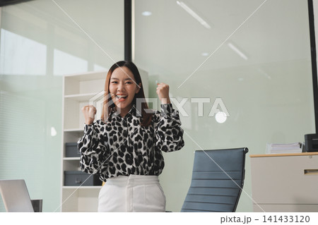Confident asian business woman standing in modern office Confident asian business woman standing in modern office 141433120