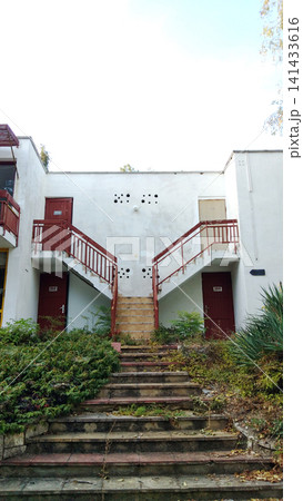 Abandoned apartment building front entrance 141433616