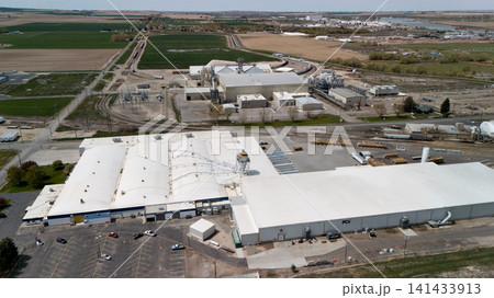 Aerial View Of Large Manufacturing Building With Parking Lot Aerial View Of Large Manufacturing Building With Parking Lot 141433913