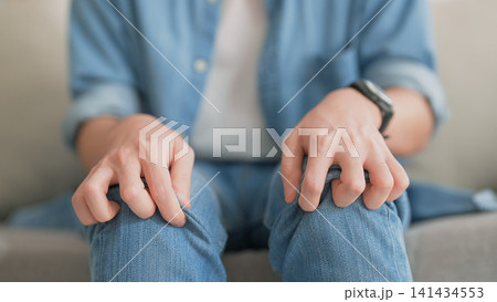 Closeup legs shaking in a guy in blue jeans. Uncontrollable leg shaking Closeup legs shaking in a guy in blue jeans. Uncontrollable leg shaking 141434553