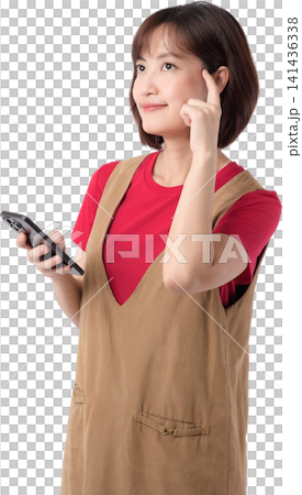 Asian woman holding smartphone with thoughtful expression isolated on transparent background posing wearing casual outfit while gesturing with finger for creative concept. PNG file format 141436338