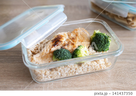 Grilled chicken breast with brown rice and broccoli in glass meal prep container. Grilled chicken breast with brown rice and broccoli in glass meal prep container. 141437350