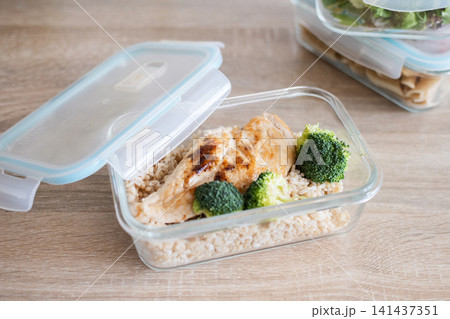 Grilled chicken breast with brown rice and broccoli in glass meal prep container. Grilled chicken breast with brown rice and broccoli in glass meal prep container. 141437351