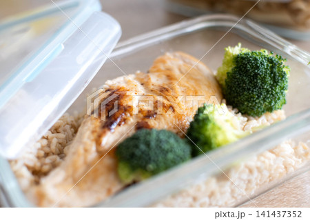 Grilled chicken breast with brown rice and broccoli in glass meal prep container. Grilled chicken breast with brown rice and broccoli in glass meal prep container. 141437352